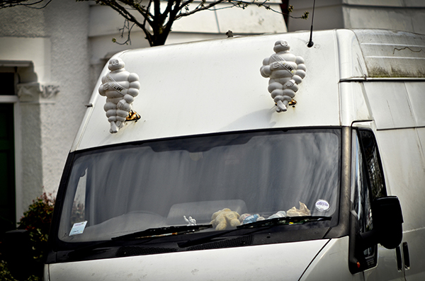 Â© Geoff Wilkinson, who writes on Wanstead Daily Photo: "Driving along Addison Road the other day I did a double take when I saw this white van. There sitting affixed to the front of the van were this pair of Michelin men, I haven't seen these for years, where have they been hiding? Michelin man is the symbol of the Michelin tyre company and was introduced at the Lyon Exhibition in 1894. It is one of the worlds oldest trademarks and always smiling."